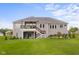 Well-maintained home exterior showcasing landscaped yard, fire pit, and tiered deck at 1497 Maple Ridge Ct, Columbus, IN 47201