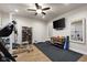 Spacious home gym with tv, free weights, exercise equipment, and hardwood flooring at 1497 Maple Ridge Ct, Columbus, IN 47201