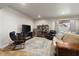 Basement area has a fireplace and TV with leather seating and a large area rug at 1497 Maple Ridge Ct, Columbus, IN 47201