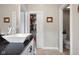 Bathroom featuring modern sink, closet access, and toilet area at 1497 Maple Ridge Ct, Columbus, IN 47201