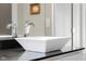 Close up of modern square vessel sink with chrome faucet atop sleek black counter at 1497 Maple Ridge Ct, Columbus, IN 47201