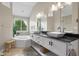 Spacious bathroom features dual sinks, modern lighting, and a relaxing soaking tub at 1497 Maple Ridge Ct, Columbus, IN 47201