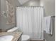 Bathroom featuring toilet, shower curtain, and decorative macrame wall hanging at 1497 Maple Ridge Ct, Columbus, IN 47201