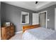 Bedroom view featuring an ensuite bath, ceiling fan, and natural light at 1497 Maple Ridge Ct, Columbus, IN 47201