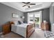 Cozy bedroom featuring a wood bed frame, carpet flooring, and large window at 1497 Maple Ridge Ct, Columbus, IN 47201