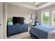 ' bedroom view with a large TV on top of a blue dresser and a work desk by the window at 1497 Maple Ridge Ct, Columbus, IN 47201