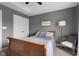 Bedroom features gray walls, crown molding, and carpeted floors, offering a serene retreat at 1497 Maple Ridge Ct, Columbus, IN 47201