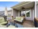 Relaxing covered patio with wicker furniture, a ceiling fan, and a view of the well-maintained yard at 1497 Maple Ridge Ct, Columbus, IN 47201