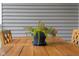 Close-up of potted plants decorating a wooden outdoor deck table at 1497 Maple Ridge Ct, Columbus, IN 47201