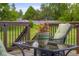 Outdoor living space with a glass-top table and a comfortable chair with green cushions at 1497 Maple Ridge Ct, Columbus, IN 47201