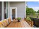 Cozy outdoor deck area with wooden table, chairs, and exterior door at 1497 Maple Ridge Ct, Columbus, IN 47201