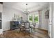Cozy dining area with a chandelier, wood flooring, and natural light streaming through the windows, creating a welcoming ambiance at 1497 Maple Ridge Ct, Columbus, IN 47201
