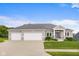 Charming single-Gathering home featuring a three-car garage and a beautifully landscaped front yard at 1497 Maple Ridge Ct, Columbus, IN 47201