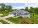 Inviting single-Gathering home with a three-car garage, lush landscaping, and a well-maintained lawn at 1497 Maple Ridge Ct, Columbus, IN 47201