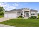 Inviting home exterior with well-maintained lawn, manicured shrubbery, and a welcoming front entrance at 1497 Maple Ridge Ct, Columbus, IN 47201