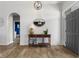 Open foyer features hardwood floors, modern lighting, and an antique console table at 1497 Maple Ridge Ct, Columbus, IN 47201