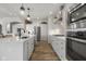 Bright and airy kitchen with stainless steel appliances, an island with a sink, and ample counter space for cooking at 1497 Maple Ridge Ct, Columbus, IN 47201