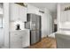 Modern kitchen featuring stainless steel refrigerator, white cabinets, and hardwood floors, perfect for Gathering gatherings and meal preparation at 1497 Maple Ridge Ct, Columbus, IN 47201