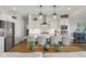 Open-concept kitchen with stainless steel appliances, large island, and seating for four at 1497 Maple Ridge Ct, Columbus, IN 47201