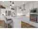 Modern kitchen with white cabinets, stainless steel appliances, and a center island with seating at 1497 Maple Ridge Ct, Columbus, IN 47201