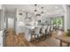 The open kitchen features white cabinets, a large island, seating, and stainless steel appliances at 1497 Maple Ridge Ct, Columbus, IN 47201