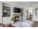 Cozy living room featuring a stone fireplace, built-in shelving, and comfortable seating arrangement at 1497 Maple Ridge Ct, Columbus, IN 47201