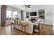 Bright living room features a fireplace, large windows, built-in shelving, and an adjacent outdoor deck at 1497 Maple Ridge Ct, Columbus, IN 47201