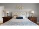 Elegant main bedroom showcasing tufted headboard, warm lighting, and dark wood nightstands to each side of the bed at 1497 Maple Ridge Ct, Columbus, IN 47201