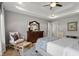 Comfortable main bedroom with a tray ceiling, dresser, chair, and ample natural light, creating a relaxing retreat at 1497 Maple Ridge Ct, Columbus, IN 47201