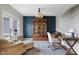 Stylish home office with a blue accent wall, custom shelving, and lots of natural light at 1497 Maple Ridge Ct, Columbus, IN 47201