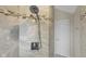 Shower with rainfall shower head and mosaic tiling at 1497 Maple Ridge Ct, Columbus, IN 47201