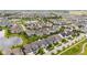 Wide aerial perspective of a residential area highlighting manicured lawns, a pond, and varied home styles at 1505 Avondale Dr, Westfield, IN 46074