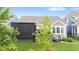 Beautiful backyard with a screened-in porch, green lawn, and professionally landscaped plants and flowerbeds at 1505 Avondale Dr, Westfield, IN 46074
