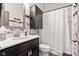 Bathroom featuring a dark vanity with a large mirror and shower with patterned wallpaper at 1505 Avondale Dr, Westfield, IN 46074