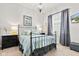 Bedroom featuring a metal bed frame, neutral walls, and decorative lighting at 1505 Avondale Dr, Westfield, IN 46074