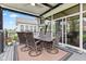 Covered deck features dining table, TV, and access to both sunroom and seating areas at 1505 Avondale Dr, Westfield, IN 46074