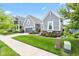 A lovely gray home sits among other colorful homes, with a sidewalk, green lawn, and beautiful landscaping at 1505 Avondale Dr, Westfield, IN 46074
