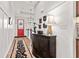 Inviting foyer with wood floors, a red front door, staircase, and stylish accent furniture at 1505 Avondale Dr, Westfield, IN 46074