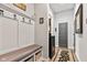 Welcoming hallway featuring a built-in bench, coat hooks, and access to the pantry and other rooms at 1505 Avondale Dr, Westfield, IN 46074