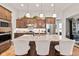 Kitchen with stainless steel appliances, large island with seating, and stylish pendant lighting at 1505 Avondale Dr, Westfield, IN 46074