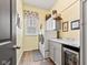 Well-organized laundry room with modern washer and dryer, cabinetry, and stylish countertop at 1505 Avondale Dr, Westfield, IN 46074