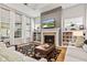 Cozy living room featuring a fireplace, built-in bookshelves, and large windows with natural lighting at 1505 Avondale Dr, Westfield, IN 46074