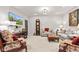 Bright living room with comfortable seating, including sofas, chairs, and a leather ottoman at 1505 Avondale Dr, Westfield, IN 46074
