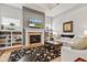 Bright living room with a fireplace, built-in bookshelves, and comfortable seating with natural light at 1505 Avondale Dr, Westfield, IN 46074