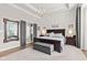 Spacious main bedroom with tray ceilings, accent wall, bench and an ensuite bath at 1505 Avondale Dr, Westfield, IN 46074