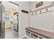 Inviting mudroom with coat hooks, bench seating, storage baskets, and access to the laundry room at 1505 Avondale Dr, Westfield, IN 46074