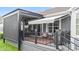 Relaxing screened-in porch with a ceiling fan, tv, and awning overlooking the manicured backyard space at 1505 Avondale Dr, Westfield, IN 46074