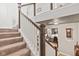 Elegant staircase with carpeted steps, wooden handrail, and views of a cozy living space at 1505 Avondale Dr, Westfield, IN 46074