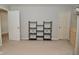 Neutral-colored bedroom with carpet, black shelving, and two doorways at 15524 Follow Dr, Noblesville, IN 46060