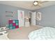 This bedroom features neutral paint colors, two shelves, and a bright, colorful organizer at 15524 Follow Dr, Noblesville, IN 46060